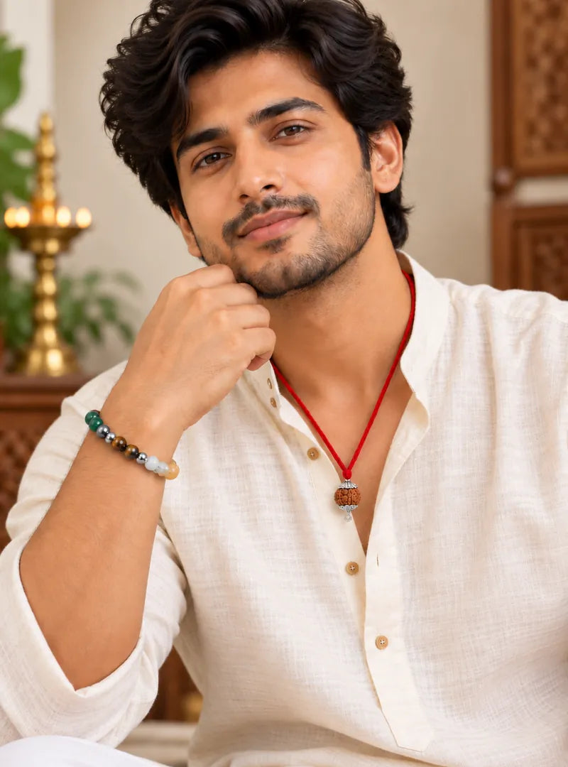 A man in a white kurta wearing the 7 Mukhi Rudraksha on a red thread and the Dhan Yog bracelet on his wrist